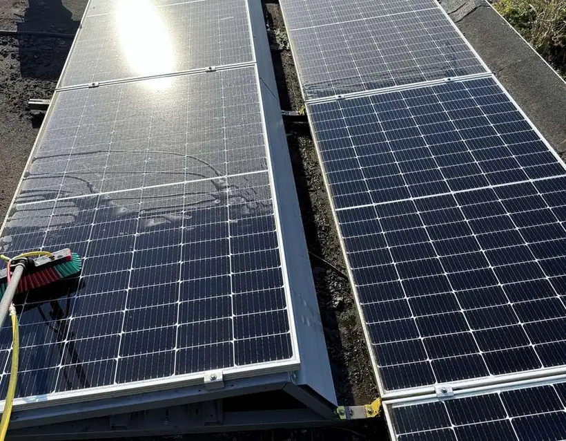 Rij zonnepanelen op een dak, halverwege de reiniging